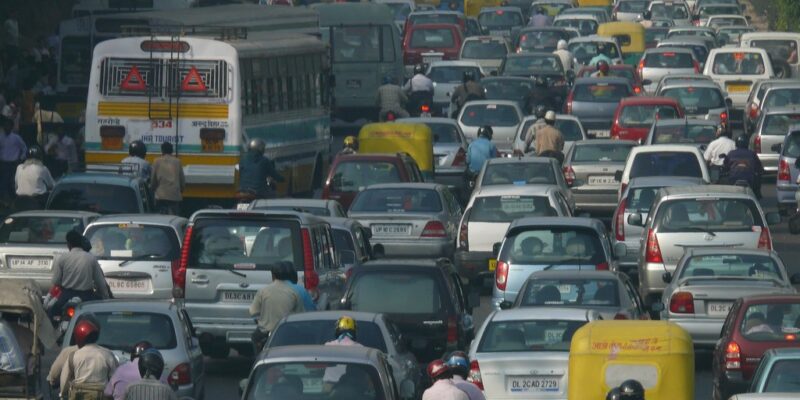 Traffic jam in New Delhi, India. Busy street containing buses, cars and people on motorbikes