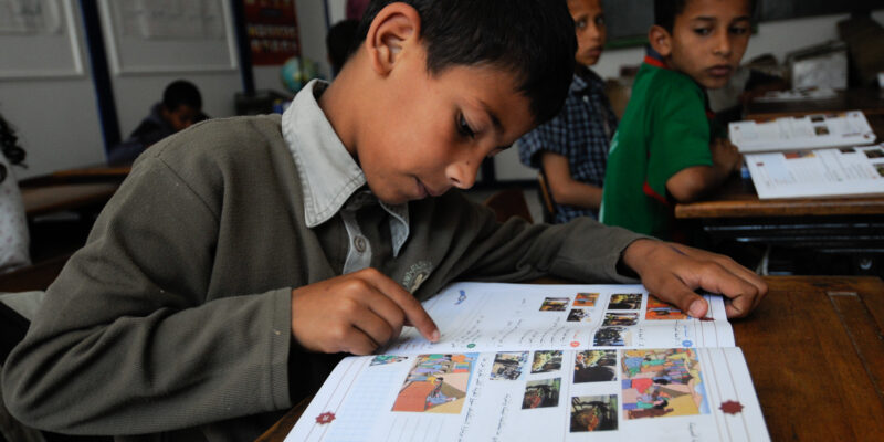Boy reading in a school