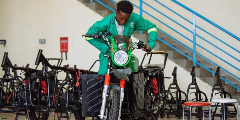 A mechanic working on a motorbike